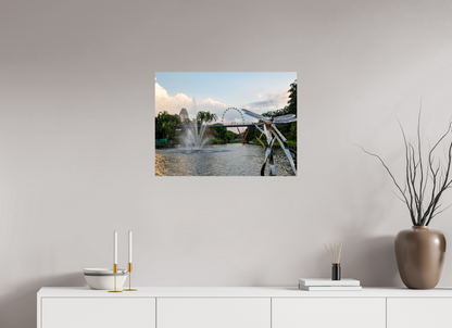 Framed photograph of a scenic view with a Ferris wheel on a wall above a white cabinet.